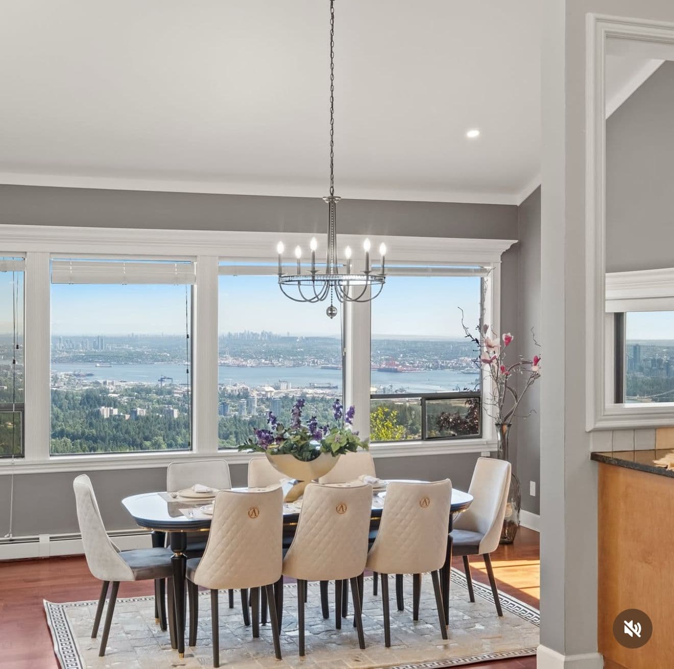 Staged dining room with a chandelier and panoramic West Vancouver city views